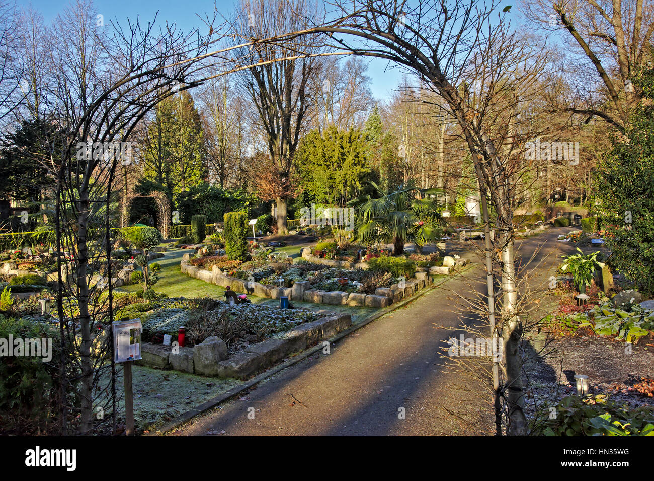 Green funeral garden with graves and urns in `MelatenFriedhof` cemetery, Cologne Stock Photo